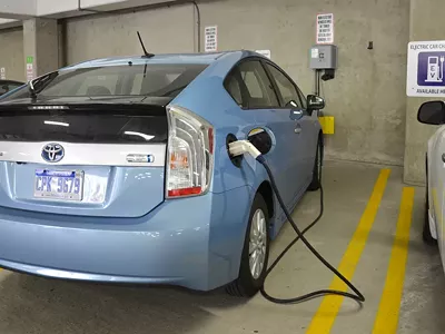 A car being charged at an electric vehicle charger in Ann Arbor.