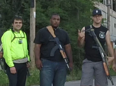 Elijah Woody (center) was arrested by Detroit police for carrying an unconcealed weapon; a rally supporting him takes place Sunday. - (From Hell's Saints' Facebook page)