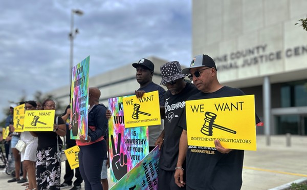 Mark Craighead (right) stands with family members of inmates who say they were falsely imprisoned because of the tactics of Detroit Police Detective Barbara Simon.