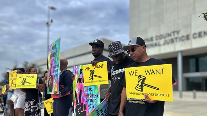 Mark Craighead (right) stands with family members of inmates who say they were falsely imprisoned because of the tactics of Detroit Police Detective Barbara Simon.