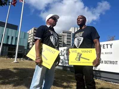 Mark Craighead (left) stands with Lamarr Monson during a rally to investigate former Detroit Detective Barbara Simon, who was involved in their wrongful convictions.