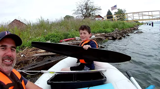 Image: Father and son fish for trash in Detroit River
