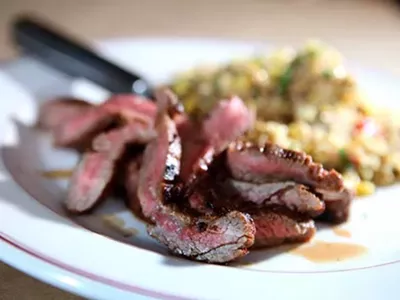 Chile-rubbed flank steak with grilled corn and quinoa salad from Vinsetta Garage in Royal Oak.
