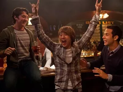 The drunk Asian dude gives 21 and Over four horns up!