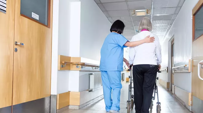 A nurse and an elderly patient.