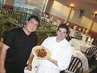 Il Gabbiano's co-owner/chefs Joe Fallea and Jonathan Rheaume serve grilled veal chop with saut&eacute;ed wild mushrooms. - Metro Times Photo / Larry Kaplan