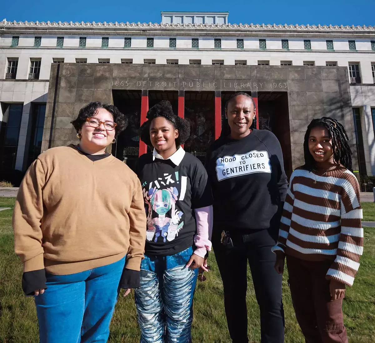 Image: Nandi Comer (center right) stands with high school students participating in nonprofit InsideOut Literary Arts’s Citywide Poets Program, which offers weekly writing workshops and performance and publishing opportunities.