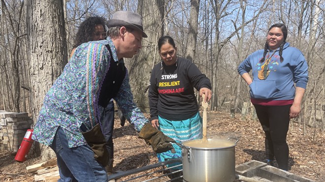 Community members boil and stir the maple syrup.