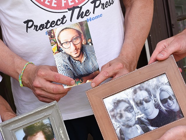 Journalist Danny Fenster's family holds photographs of him at their Huntington Woods home.
