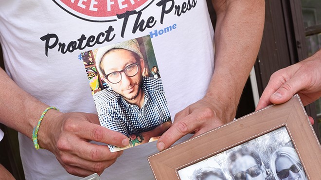 Journalist Danny Fenster's family holds photographs of him at their Huntington Woods home.