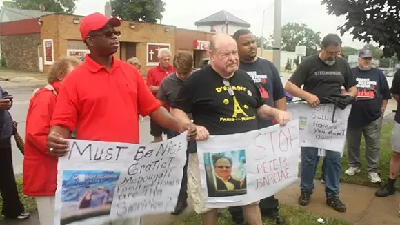 Representatives from the Detroit Eviction Defense and Detroit Residents protested outside a Singapore-based real estate firm’s office in Pontiac on July 24, 2013, arguing for certain home listings to be removed. - Detroit Eviction Defense