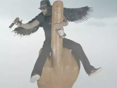 Image: Kid Rock really likes guns, compares himself to Brad Pitt, and rides a phallic middle-finger rocket in new music video