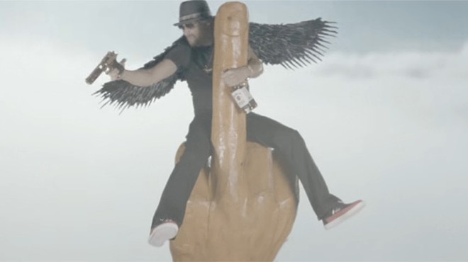 Kid Rock really likes guns, compares himself to Brad Pitt, and rides a phallic middle-finger rocket in new music video
