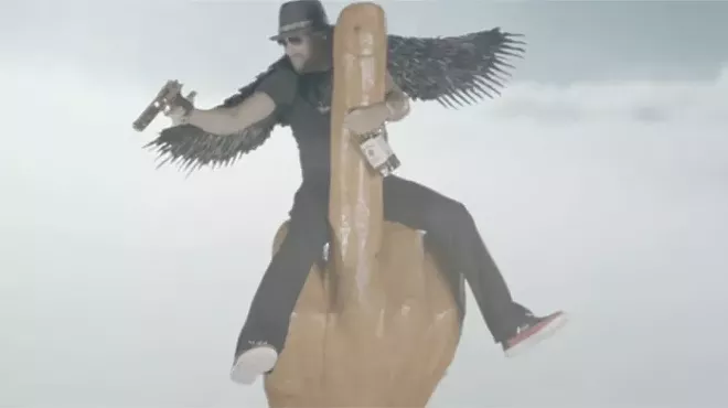 Image: Kid Rock really likes guns, compares himself to Brad Pitt, and rides a phallic middle-finger rocket in new music video