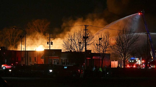 Fire departments battle an industrial fire near 15 Mile Road and Groesbeck Highway in Clinton Township on Monday.