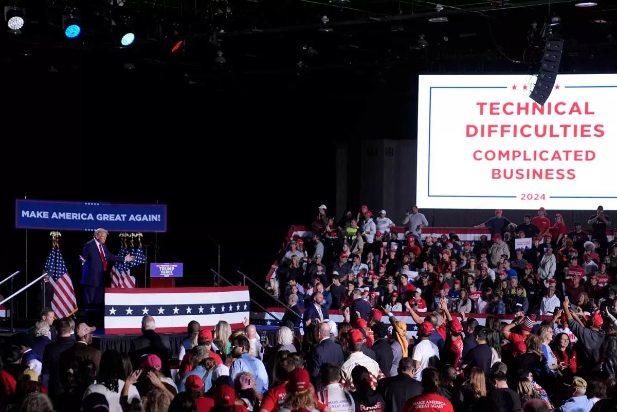 Image: Republican presidential nominee former President Donald Trump pauses during technical difficulties at a campaign rally, Friday, Oct. 18, 2024, in Detroit.
