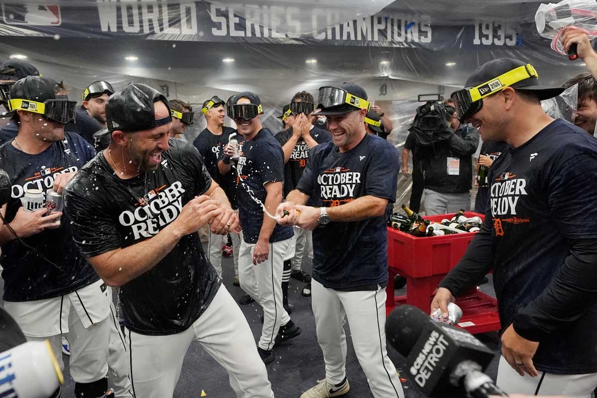 The Detroit Tigers celebrate their AL wild card berth after the ninth inning of a baseball game against the Chicago White Sox, Friday, Sept. 27, 2024, in Detroit.