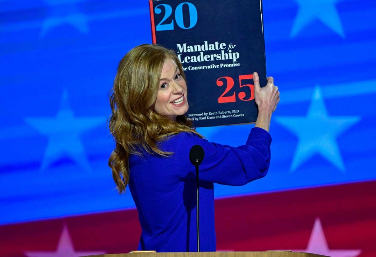 Michigan State Senator Mallory McMorrow hauls out a “Project 2025” prop at the 2024 Democratic National Convention in Chicago.