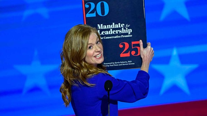 Michigan State Senator Mallory McMorrow hauls out a “Project 2025” prop at the 2024 Democratic National Convention in Chicago.