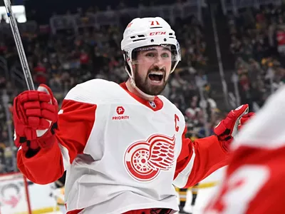 Detroit Red Wings captain Dylan Larkin models the team’s new uniform, sponsored by Priority Waste Management.