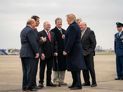 Sen. Kennedy, center, and other Republicans greeting President Trump in 2019.