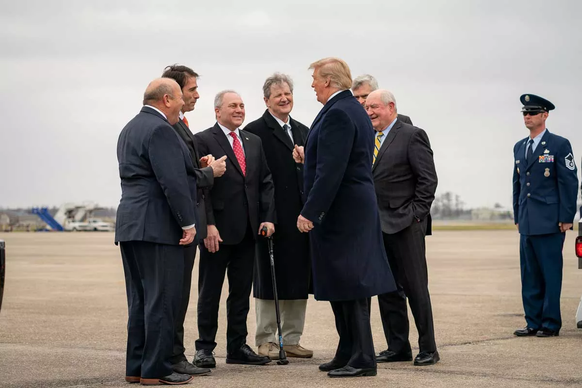 Image: Sen. Kennedy, center, and other Republicans greeting President Trump in 2019.