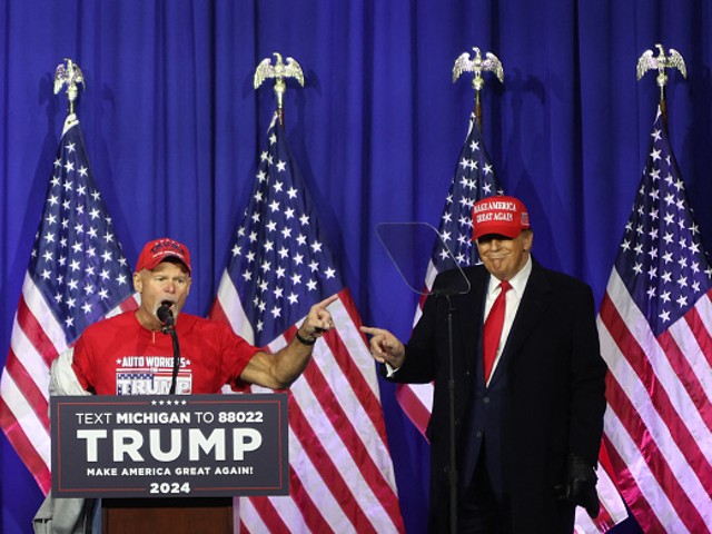 “Look at these muscles”: Former President Donald Trump brings a retired autoworker on stage at a Waterford rally.
