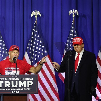 “Look at these muscles”: Former President Donald Trump brings a retired autoworker on stage at a Waterford rally.