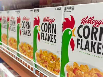 Kellog's Corn Flakes on display at an aisle in a supermarket.