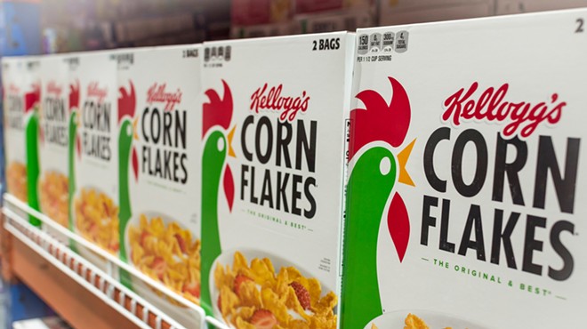 Kellog's Corn Flakes on display at an aisle in a supermarket.
