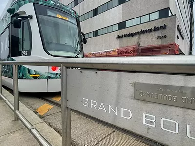 The signs at the QLine stops are written in braille and English that appears inverted.