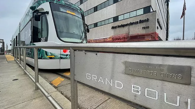 The signs at the QLine stops are written in braille and English that appears inverted.