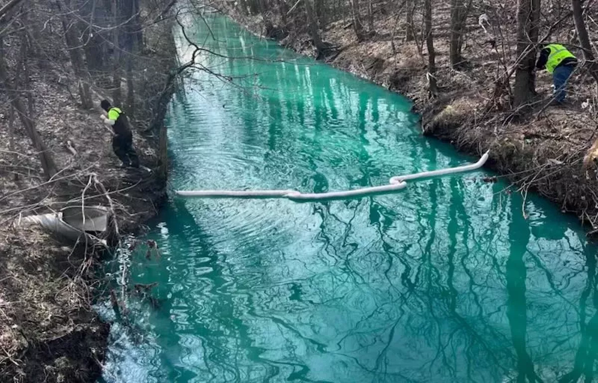 Image: Pollution caused Bear Creek in Warren to turn fluorescent blue in 2024.