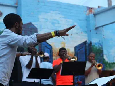 Marcus Elliot leads a performance of his composition “Beyond Rebellious” at the 2017 Detroit Artist Village Sidewalk Festival.