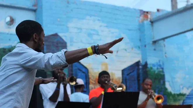 Marcus Elliot leads a performance of his composition “Beyond Rebellious” at the 2017 Detroit Artist Village Sidewalk Festival.