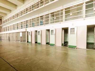 A former employee of the Michigan Department of Corrections has sued the agency and its spokesman for alleged retaliation, sexual abuse.