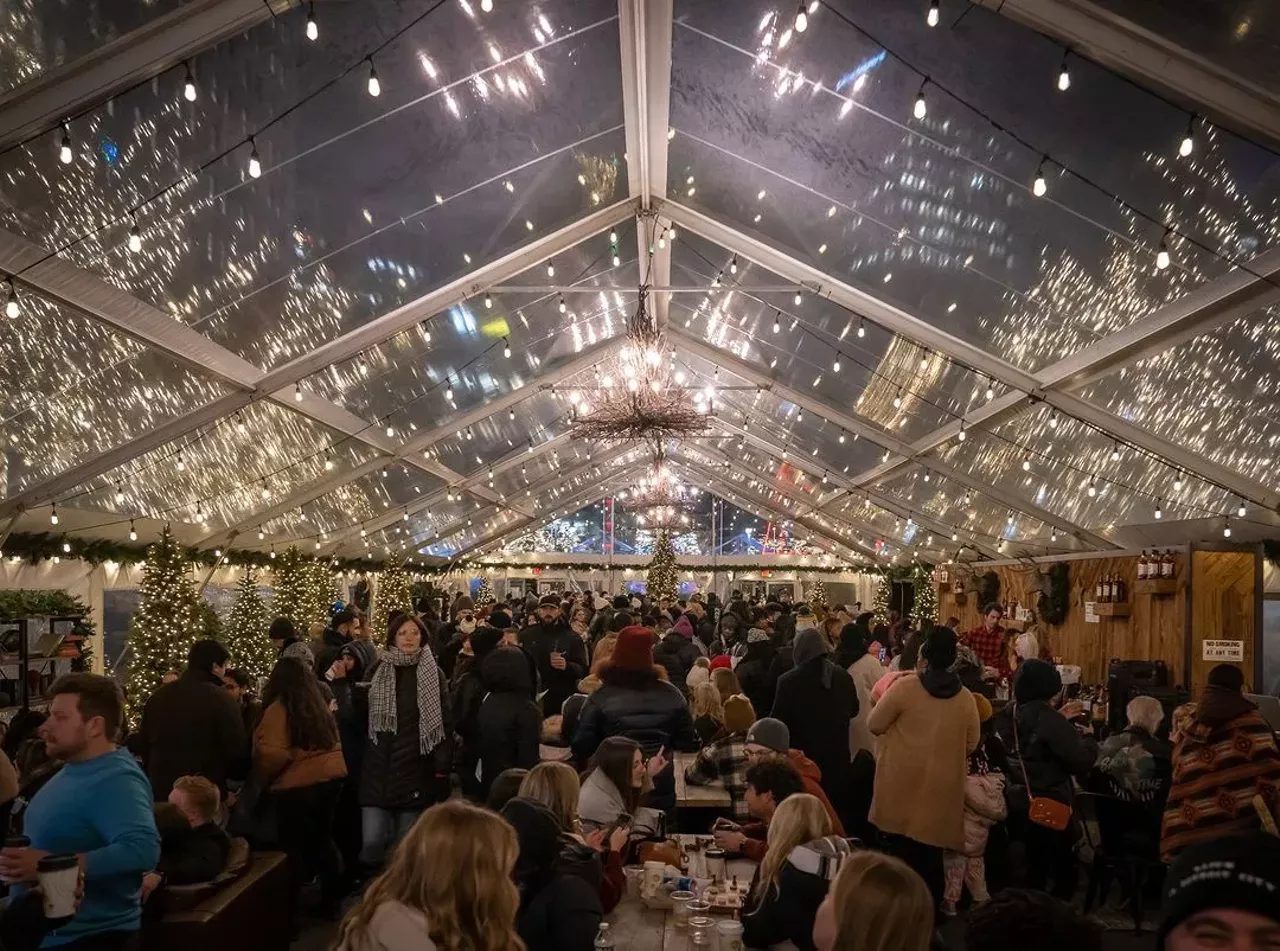 Cadillac Lodge
This festive and large warm tent is an iconic tradition for metro Detroit during the holidays. The lodge is filled with board games, seating, fireplaces, and holiday drinks. Plus, right outside are the Cadillac Square winter markets, perfect for local holiday shopping. New Year’s Day is the final day open for both the lodge and the markets.