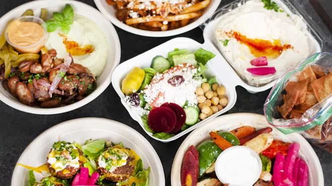 Counterclockwise bottom left to right: Loaded falafel, fooul, shawarma fries, hummus, beef tenderloin bowl, and salad.