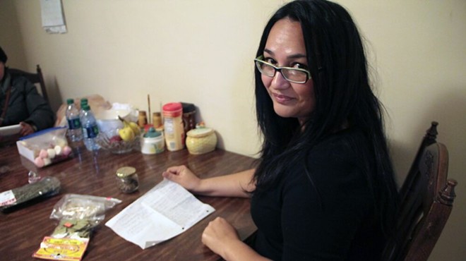 Ofelia Saenz with a list of ingredients for Dona Marta Nino's family mole.