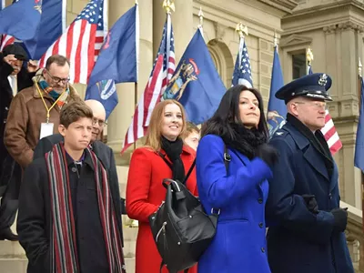 Col. Kevin Bohnsack, state air surgeon, Michigan Air National Guard, escorts Michigan Attorney General-elect Dana Nessel to the Capitol dais at the inauguration of Gov. Gretchen Whitmer, Lansing, Mich., Jan. 1, 2019.