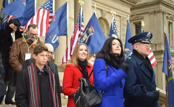 Col. Kevin Bohnsack, state air surgeon, Michigan Air National Guard, escorts Michigan Attorney General-elect Dana Nessel to the Capitol dais at the inauguration of Gov. Gretchen Whitmer, Lansing, Mich., Jan. 1, 2019.