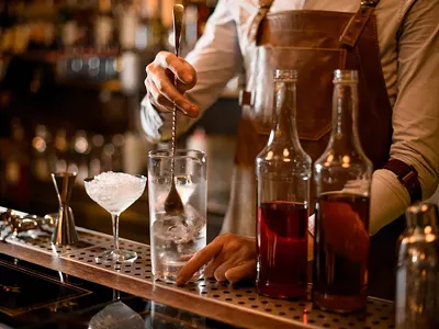 A bartender makes cocktails.