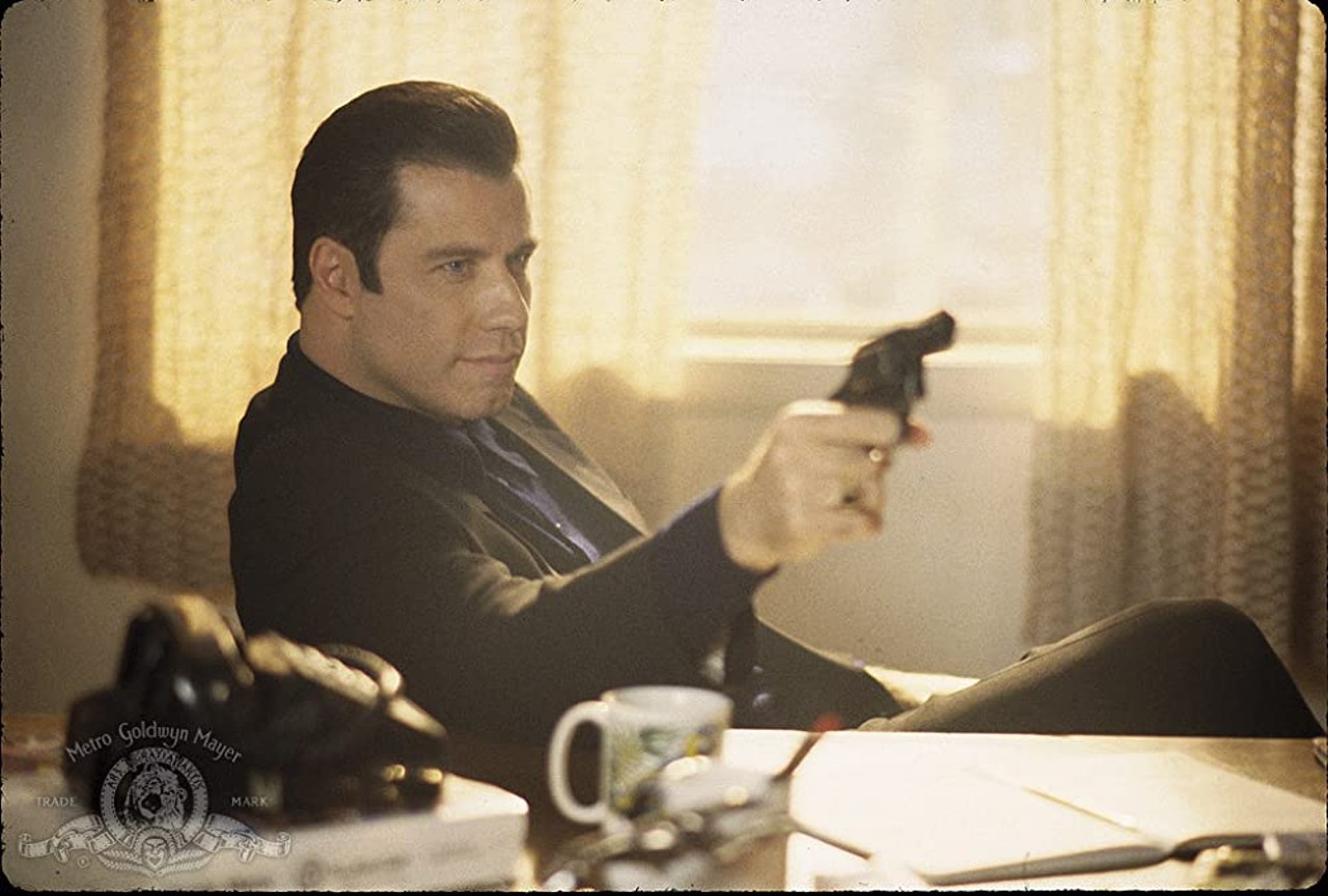 Get Shorty (1995)
Directed by Barry Sonnenfeld. Written by Scott Frank. Produced by Danny DeVito, Michael Shamberg, and Stacey Sher.
Quite possibly the best film based on Leonard’s work, Get Shorty was praised for its star-studded cast (featuring John Travolta, Gene Hackman, Rene Russo, Delroy Lindo, James Gandolfini, Dennis Farina, and Danny DeVito) and its searing postmodern satire of show business. It was based on Loenard’s 1990 novel, his 28th, about Ernest “Chili” Palmer, a real-life Miami loan shark played by Travolta who earned a Golden Globe (Best Actor in a Comedy or Musical) for his performance.
