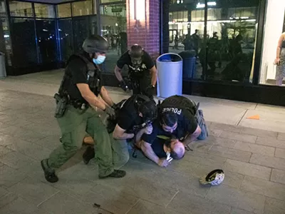 Detroit police tackle a protester early Sunday morning.