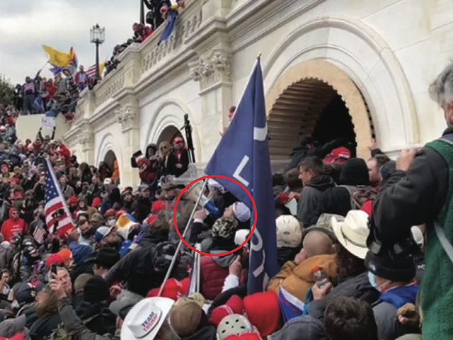 Trevor Brown is circled in red near the front of a violent crowd that was trying to push past police officers at a tunnel at the U.S. Capitol.