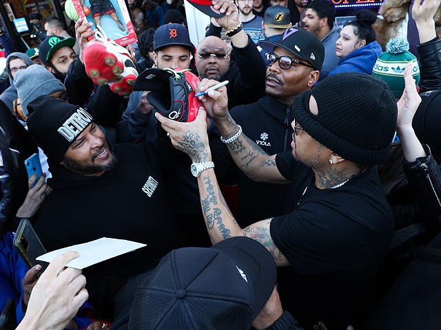 Allen Iverson signs merch on a visit to Michigan cannabis dispensaries.