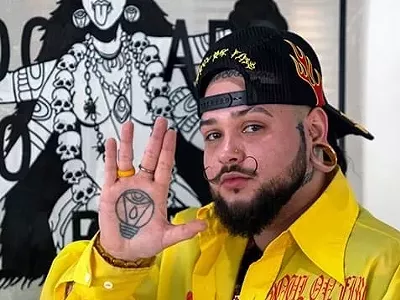 Blight Hernandez with his "Kali Through Detroit" painting.