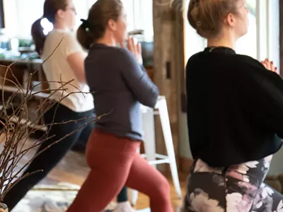 Cannabis retreat guests relax with yoga at a getaway in Clymer, New York.