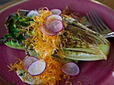 Charred romaine with bottarga dressing, mimolette, and radish from Coeur.