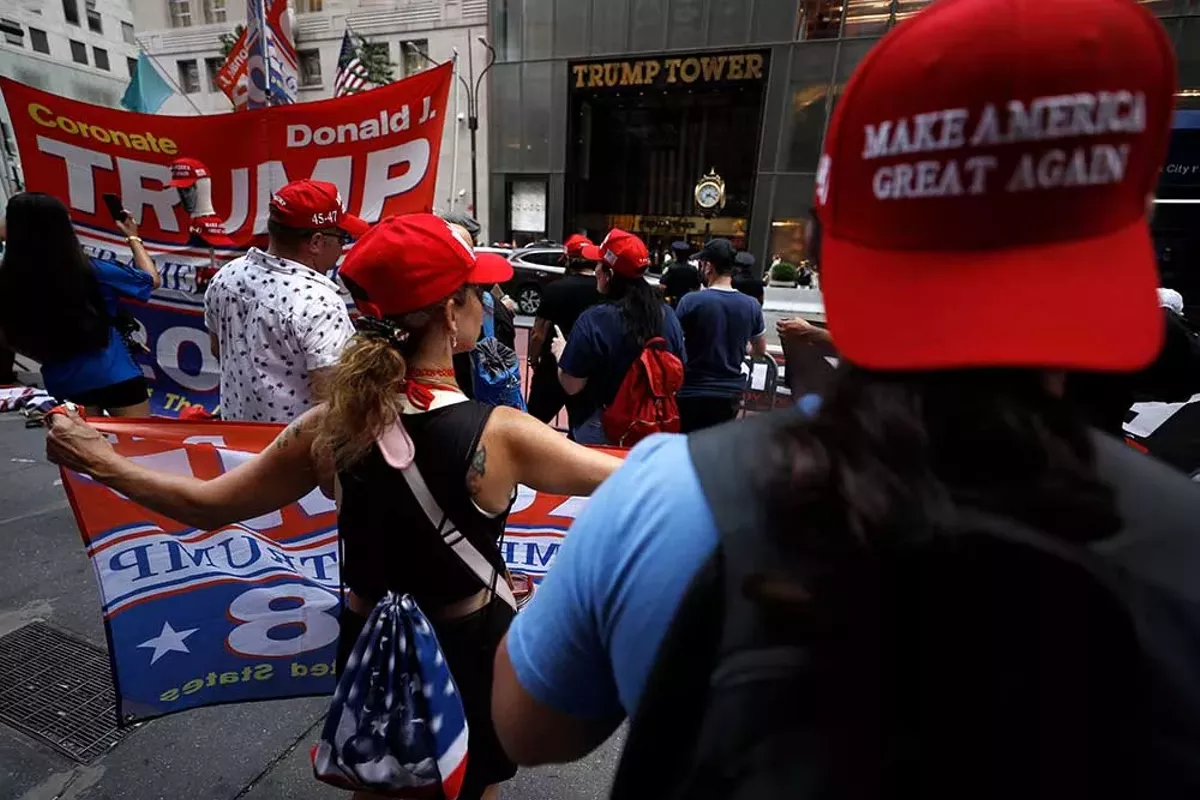 Image: Supporters of former President Donald Trump’s gather with flags in front of his Fifth Avenue residence on July 14, 2024 in New York City.